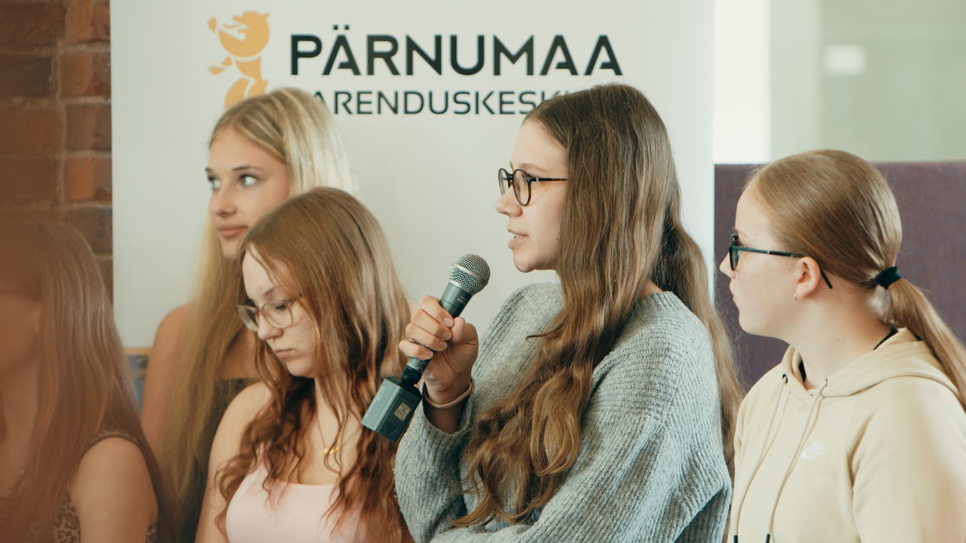 Noored esitlevad mängujuhi rolli uuringut mikrofoniga